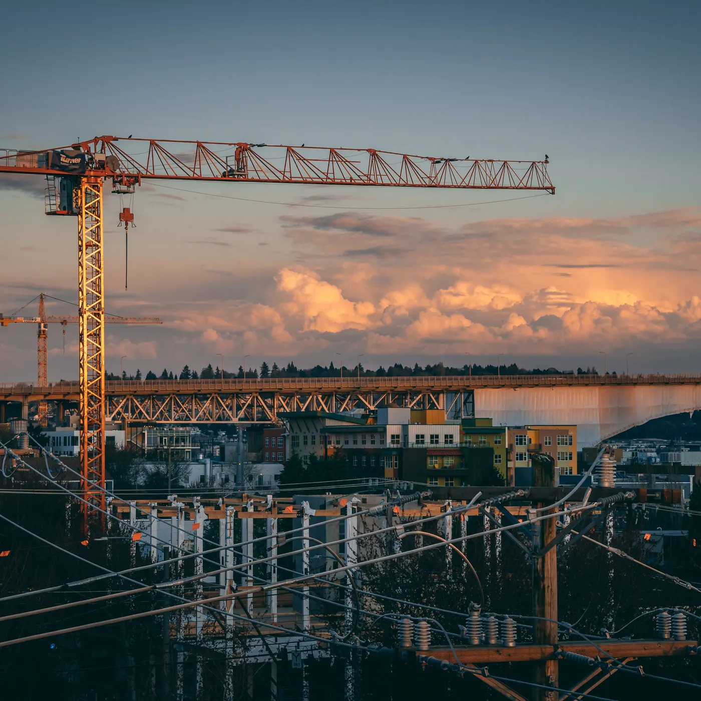 Tower crane over a construction site at dusk
